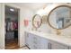 Bright bathroom features double sinks, granite countertops, modern lighting, and access to closet at 6349 N 78Th St # 105, Scottsdale, AZ 85250