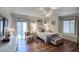 Serene bedroom with ceiling fan, wood floors, and access to outdoor patio at 6349 N 78Th St # 105, Scottsdale, AZ 85250