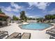 Community pool area with lounge chairs, clear blue water, spa, and lush greenery offers a resort-style experience at 6349 N 78Th St # 105, Scottsdale, AZ 85250