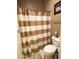 Functional bathroom with shower/tub combination and neutral striped shower curtain at 6535 E Superstition Springs Blvd # 217, Mesa, AZ 85206