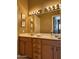 Bathroom featuring double sink vanity with a large mirror and decorative lighting at 6535 E Superstition Springs Blvd # 217, Mesa, AZ 85206