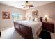 Charming bedroom features a queen-size bed, ceiling fan, and a scenic view from the window at 6535 E Superstition Springs Blvd # 217, Mesa, AZ 85206