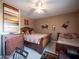 Comfortable bedroom with ceiling fan, dark wood furniture, and decorative wall art at 6535 E Superstition Springs Blvd # 217, Mesa, AZ 85206