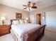 Cozy bedroom with a ceiling fan, nightstands, and an attached bathroom and closet at 6535 E Superstition Springs Blvd # 217, Mesa, AZ 85206