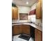 Functional kitchen with oak cabinets and black appliances at 6535 E Superstition Springs Blvd # 217, Mesa, AZ 85206