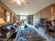 Inviting living room with large leather sofa, glass coffee table, entertainment center, and balcony access at 6535 E Superstition Springs Blvd # 217, Mesa, AZ 85206