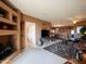 Open living room showcasing neutral tones, carpet, entertainment area, and dining space at 6535 E Superstition Springs Blvd # 217, Mesa, AZ 85206