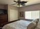 A comfortable main bedroom with a decorative ceiling fan and natural light at 6535 E Superstition Springs Blvd # 217, Mesa, AZ 85206