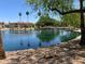 Beautiful pond with lush landscaping and lovely apartments in the background on a sunny day at 6535 E Superstition Springs Blvd # 217, Mesa, AZ 85206