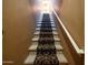 Carpeted staircase leading to the upper level with neutral walls and a white handrail at 6535 E Superstition Springs Blvd # 217, Mesa, AZ 85206