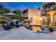 Beautiful backyard with pool and waterfall feature, lush landscaping, and outdoor seating at 6701 N Scottsdale Rd # 26, Scottsdale, AZ 85250