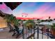 Cozy balcony seating offering a peaceful spot to enjoy panoramic views and the vibrant colors of the evening sky at 6701 N Scottsdale Rd # 26, Scottsdale, AZ 85250