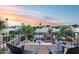 Balcony featuring a fireplace and seating area with scenic views of palm trees and the city at sunset at 6701 N Scottsdale Rd # 26, Scottsdale, AZ 85250