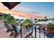 Balcony featuring a seating area with scenic views of palm trees and the city at sunset at 6701 N Scottsdale Rd # 26, Scottsdale, AZ 85250
