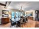 Elegant dining room featuring a long wood table, ornate chandelier, and sliding doors to the pool area at 6701 N Scottsdale Rd # 26, Scottsdale, AZ 85250