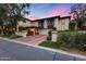 Charming two-story home featuring a terracotta roof, landscaped front yard, and private balconies with decorative accents at 6701 N Scottsdale Rd # 26, Scottsdale, AZ 85250