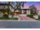 Charming two-story stucco home with a red tile roof, lush landscaping, and a spacious driveway at 6701 N Scottsdale Rd # 26, Scottsdale, AZ 85250