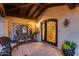 Inviting front entrance with dark wood accents and decorative iron door and sidelight at 6701 N Scottsdale Rd # 26, Scottsdale, AZ 85250
