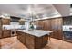 Spacious kitchen boasts a large island, stainless steel appliances, and custom wood cabinetry at 6701 N Scottsdale Rd # 26, Scottsdale, AZ 85250