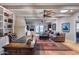 Cozy living room featuring a fireplace, wood ceiling, skylights, ceiling fan, and hardwood floors at 6701 N Scottsdale Rd # 26, Scottsdale, AZ 85250