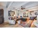 Comfortable living room with wood ceiling, skylights, ceiling fan, and hardwood floors at 6701 N Scottsdale Rd # 26, Scottsdale, AZ 85250