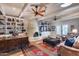 Inviting living room with wood ceiling, skylights, ceiling fan, fireplace, and custom built-ins at 6701 N Scottsdale Rd # 26, Scottsdale, AZ 85250