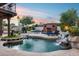 Outdoor pool and fireplace, a seamless blend of luxury and tranquility, with plenty of room for seating and relaxation at 6701 N Scottsdale Rd # 26, Scottsdale, AZ 85250