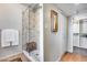 Glass-enclosed shower with tiled walls, a built-in bench, and convenient towel racks at 6701 N Scottsdale Rd # 26, Scottsdale, AZ 85250
