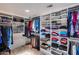 Spacious walk-in closet with custom shelving for shoes, folded clothes, and hanging clothes at 6701 N Scottsdale Rd # 26, Scottsdale, AZ 85250