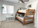 Bedroom featuring rustic bunkbeds, ceiling fan, carpet, and window at 694 W Park Ave, Chandler, AZ 85225