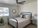 Bedroom featuring a ceiling fan, window, and comfortable bed with end tables at 694 W Park Ave, Chandler, AZ 85225