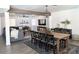 Open-concept dining room featuring a large wooden table, modern lighting, and a view into the living area at 694 W Park Ave, Chandler, AZ 85225
