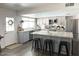Spacious kitchen with granite island, stainless appliances, and stylish cabinetry, flowing into other living spaces at 694 W Park Ave, Chandler, AZ 85225