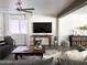 Inviting living room featuring modern décor, wood beam accents, and ample natural light at 694 W Park Ave, Chandler, AZ 85225
