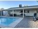 Backyard oasis featuring a sparkling pool and covered patio with seating and dining areas at 694 W Park Ave, Chandler, AZ 85225