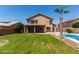 Stunning backyard showcasing a refreshing pool and lush green lawn at 7179 W Surrey Ave, Peoria, AZ 85381
