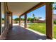 Covered patio overlooking the lush backyard with a sparkling pool at 7179 W Surrey Ave, Peoria, AZ 85381