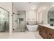 Spa-like bathroom featuring a soaking tub and glass-enclosed shower at 7179 W Surrey Ave, Peoria, AZ 85381