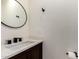 Modern bathroom vanity with white countertop and dark hardware at 7179 W Surrey Ave, Peoria, AZ 85381