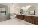 Bright bathroom with dual vanities, freestanding tub, and glass shower at 7179 W Surrey Ave, Peoria, AZ 85381