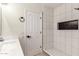 Stylish bathroom showcasing white tile shower with a niche and tiled floor, complemented by modern fixtures at 7179 W Surrey Ave, Peoria, AZ 85381