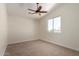 Well-lit bedroom featuring neutral carpet, trim, and a window for natural light at 7179 W Surrey Ave, Peoria, AZ 85381