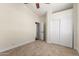 Bright bedroom with carpet, fan, vaulted ceiling and a large closet at 7179 W Surrey Ave, Peoria, AZ 85381