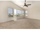 Spacious bedroom featuring a ceiling fan and large windows at 7179 W Surrey Ave, Peoria, AZ 85381