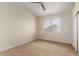 Cozy bedroom featuring neutral carpet, ceiling fan, and a bright window at 7179 W Surrey Ave, Peoria, AZ 85381