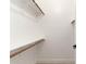 Walk-in closet with built-in shelving and wooden rods, maximizing storage space at 7179 W Surrey Ave, Peoria, AZ 85381