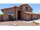 Two-story home with a red tile roof, three-car garage and desert landscaping at 7179 W Surrey Ave, Peoria, AZ 85381