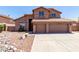 Two-story home with a red tile roof, three-car garage and low-maintenance desert landscaping at 7179 W Surrey Ave, Peoria, AZ 85381