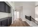 Inviting hallway with dark wood floors and cabinets, leading to other rooms at 7179 W Surrey Ave, Peoria, AZ 85381