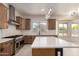 Well-equipped kitchen with a stainless steel range, custom cabinets, and center island, perfect for cooking at 7179 W Surrey Ave, Peoria, AZ 85381